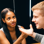 **Image:** A diverse group of people engaged in a conversation. One person is actively listening, making eye contact, and nodding attentively, while another person is speaking and gesturing with their hands. Soft, warm lighting enhances the feeling of connection and understanding. The background is blurred, focusing on the interaction. **Keywords:** Active listening, empathy, connection, communication, non-verbal cues, understanding, support.